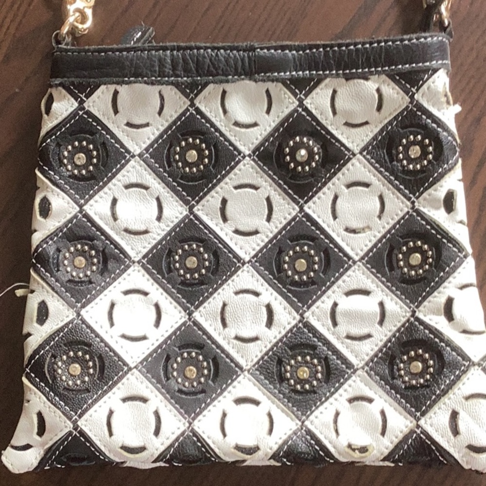 Unique artsy handbag made with leather and metal and crystal embellishments